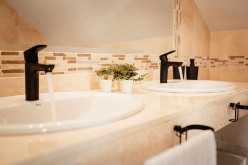 two sinks in a bathroom with two faucets at Tinajas Chic in Corralejo