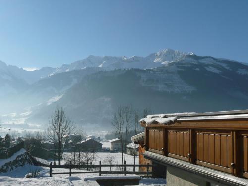 a snow covered roof of a house with mountains in the background at Haus Rosi in Uttendorf