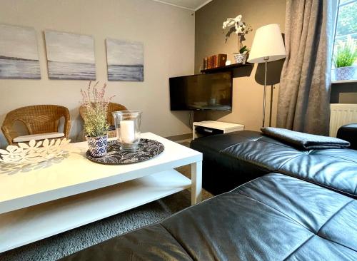 a living room with a couch and a coffee table at Beachhouse Schwedeneck in Surendorf