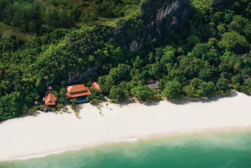 an aerial view of a house on an island in the water at Four Seasons Resort Langkawi in Tanjung Rhu