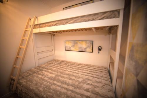 a bunk bed in a room with a ladder at Le Rosset in Tignes