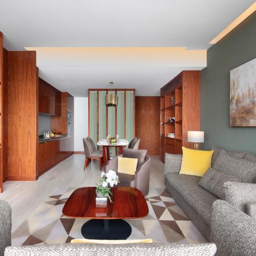 a living room with a couch and a table at The Bentley Luxury Hotel & Suites in Doha