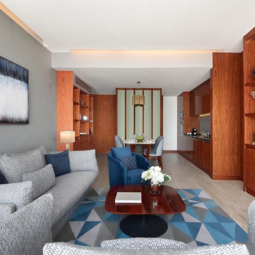 a living room with a couch and a table at The Bentley Luxury Hotel & Suites in Doha