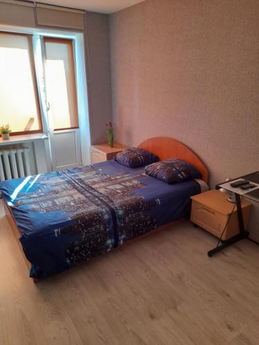 a bedroom with a bed in a room with a window at Promenade Central Apartment in Liepāja