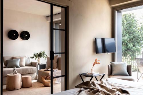 a bedroom with a bed and a tv and a couch at Laqua by the lake in Pettenasco
