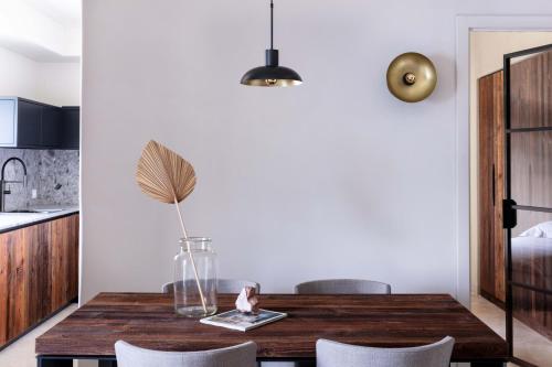 a dining room with a wooden table and chairs at Laqua by the lake in Pettenasco