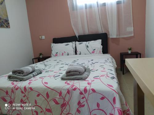 1 dormitorio con 1 cama con toallas en the comfort place רותם המדבר, en Merhav Am