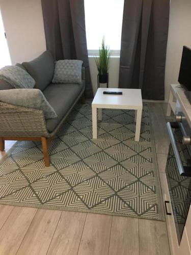 a living room with a couch and a coffee table at apartment Juurikoskenkatu in Ylivieska