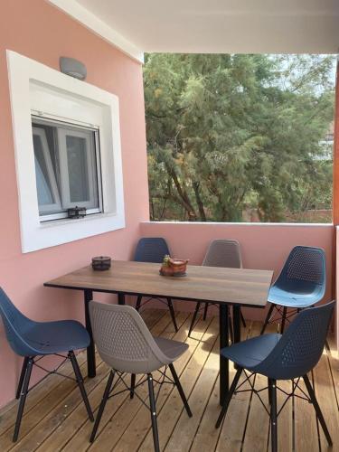 a table and chairs in a room with a window at Perland Vacation in Sidari