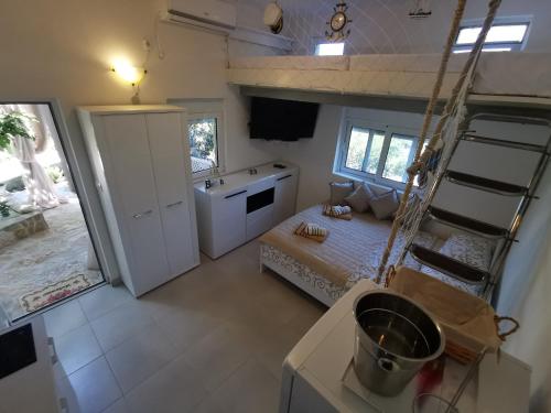 a small room with a bed and a ladder in it at STUDIO Carpe Diem in Utjeha