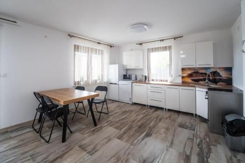 a kitchen with a table and chairs in a room at Michalka 1 - Domki pod Leskowcem in Targoszów