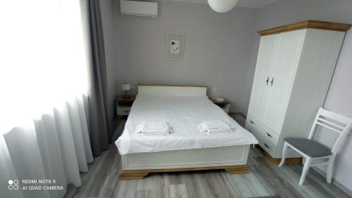 A bed or beds in a room at Lighthouse Apartments and Villas