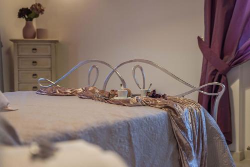 a bed with a blue blanket and two cups on it at Villa Design in Pergola