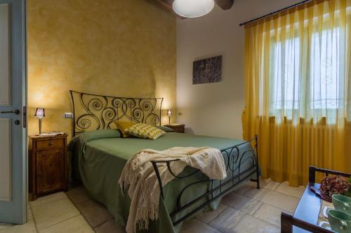 a bedroom with a green bed and a window at Villa Design in Pergola