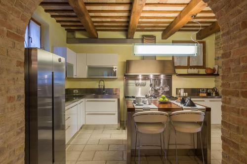 a kitchen with a stainless steel refrigerator and a counter at Villa Design in Pergola