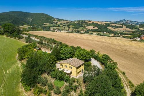 an aerial view of a house on a hill with a field at Villa Design in Pergola