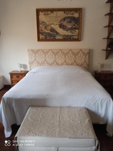 a bedroom with a bed with a bench in it at Catherine's Home in Rome