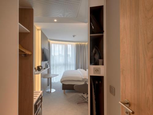 a small room with a bed and a bedroom at Holiday Inn Express - Offenbach by IHG in Offenbach