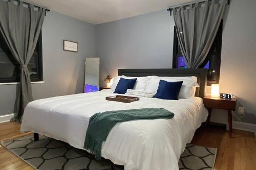 a bedroom with a large white bed with blue pillows at Reduced Priced! Apt by American Dream, Sleeps 6 in Lodi
