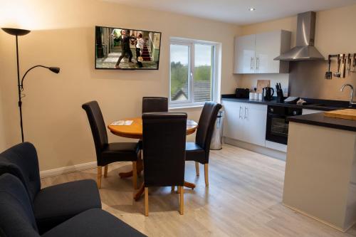 a kitchen and living room with a table and chairs at The Anchor Inn in Hartland