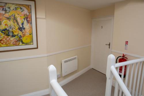 a room with a painting on the wall and stairs at The Anchor Inn in Hartland