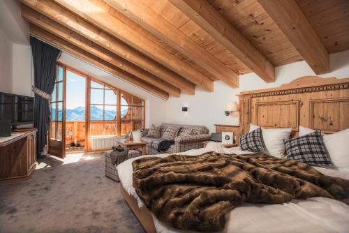 a bedroom with a large bed and a living room at Kristallhütte in Zellberg