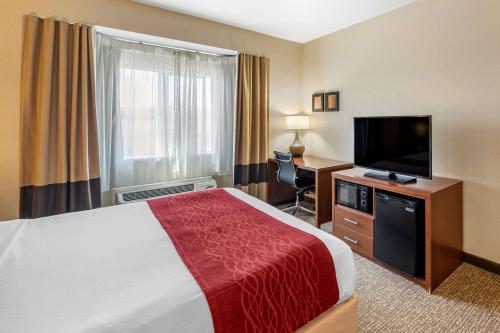 a hotel room with a bed and a television at Comfort Inn & Suites San Francisco Airport West in San Bruno
