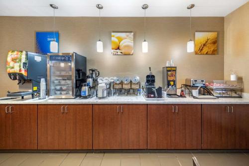 a kitchen with a counter with a coffee maker at THE ATRIUM HOTEL - SFO AIRPORT FREE! - Shuttle Bus - Parking - WIFI in San Bruno