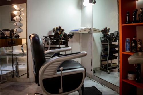 a salon with a chair in front of a mirror at Hotel Atlantic Agdal in Rabat