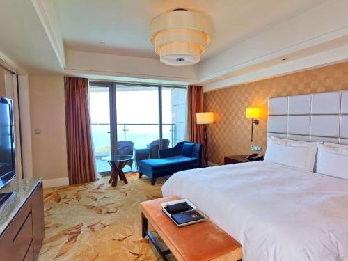 a hotel room with a large bed and a television at Fairmont Yangcheng Lake in Kunshan
