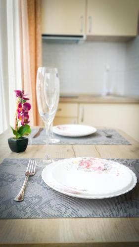 a table with a plate and a fork and a glass at Лайт студия Вокзал Харьков-Пассажирский in Kharkiv