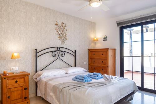 a bedroom with a bed with towels on it at Villa Simba in Corralejo
