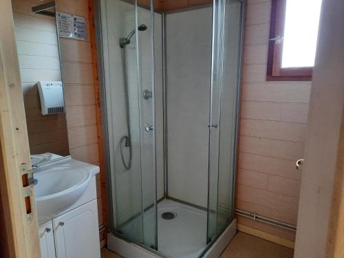 a bathroom with a shower and a sink at Camping de la Bageasse in Brioude