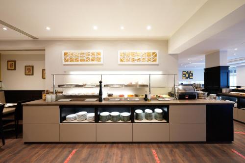 a kitchen with a counter with food on it at Hotel Bayerischer Hof in Bayreuth