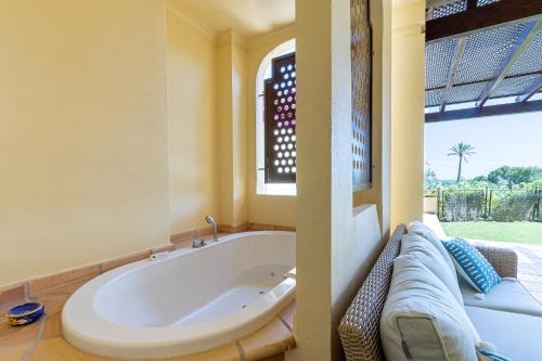 a large bath tub in a room with a window at BELLA GADEA in Altea