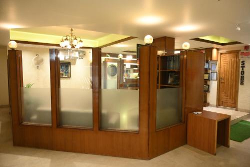 a display case in a room with glass at Hotel Grand Kailash,Kotdwara in Kotdwāra