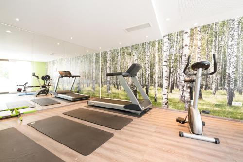 a gym with a wall mural of aspen trees at Hotel Bayerischer Hof in Bayreuth