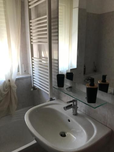 a white sink in a bathroom with a window at L'Alloggio Perfetto in Putignano
