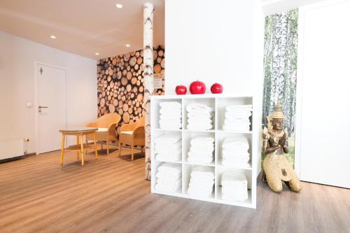 a room with a white shelf filled with plates at Hotel Bayerischer Hof in Bayreuth