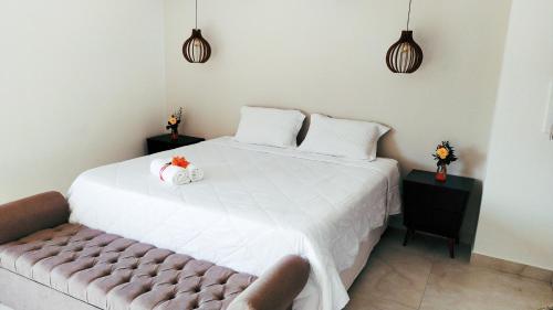 a bedroom with a bed with two stuffed animals on it at Pousada Quintal da Lua in Capitólio