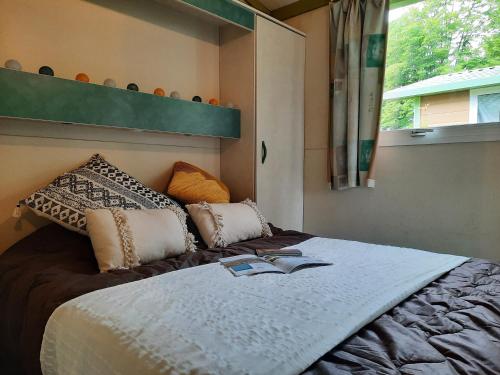 A bed or beds in a room at Camping de Decize