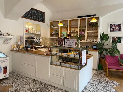 a shop with a counter and a person in a room at Charles Square Hostel in Prague