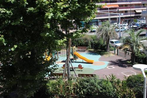 a playground with a slide in a park at Appartement 3 pièces en duplex in Antibes