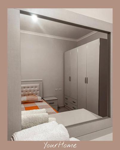 a room with two beds and a mirror at YourHome in Tirana