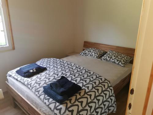 a bedroom with a bed with two pillows on it at Počitniška HIŠKA POLOVNIK in Bovec