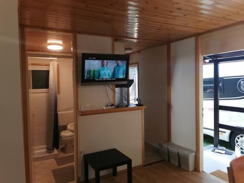a living room with a flat screen tv on the wall at Počitniška HIŠKA POLOVNIK in Bovec