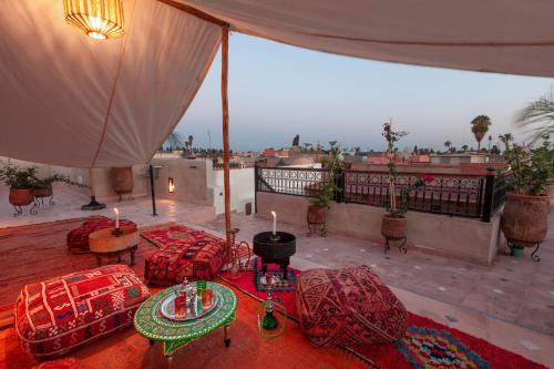 a room with red pillows and candles on a balcony at Riad Salman in Marrakech