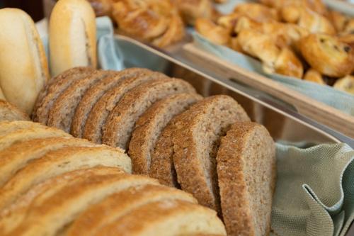 a bunch of loaves of bread on display in a bakery at Hotel Roma in Palmanova