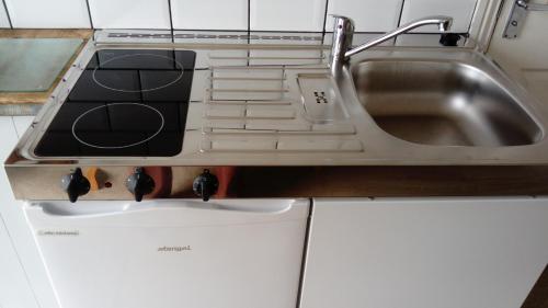 a kitchen with a sink next to a sink at The Stables self catering in Seahouses