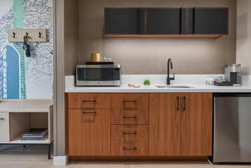 a kitchen with a sink and a microwave at The Watermark Hotel in Tysons Corner
